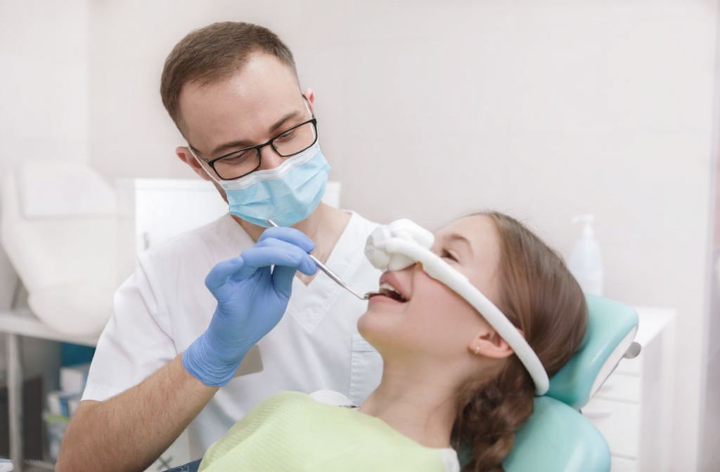 A teen is administered nitrous oxide throughout the dental procedure.