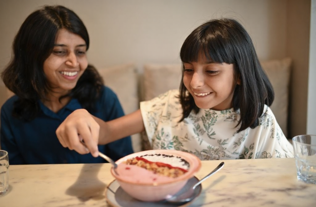 A child enjoys a filling smoothie bowl as a satisfying snack after her root canal.