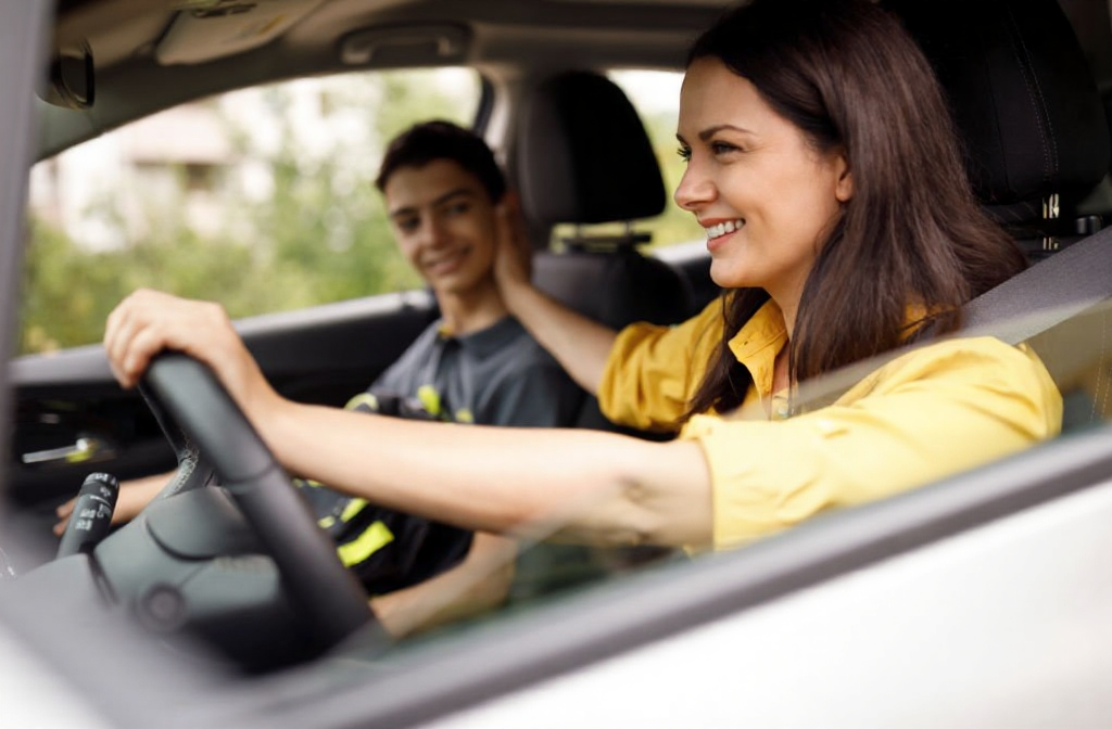A woman drives her son home after his root canal appointment.