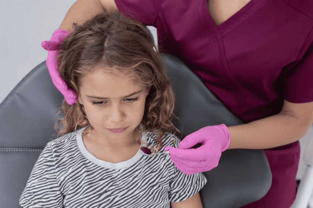 A young girl is anxious before a filling takes place.