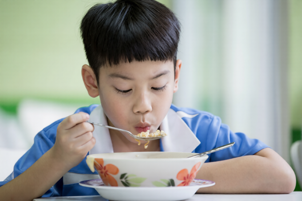 A child eats lukewarm, soft and easy-to-swallow soup after a root canal.