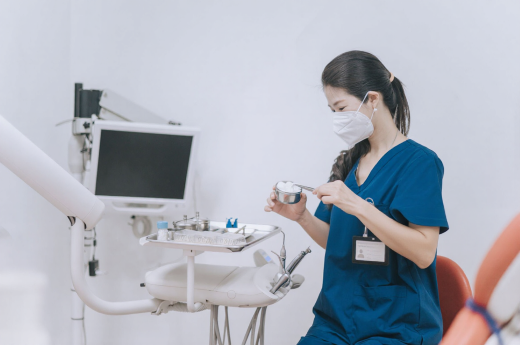 A nurse is preparing medical instruments in the dentist's office before the appointment.