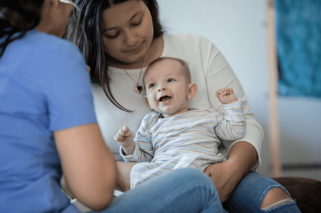 A mother takes her infant for a dental checkup.