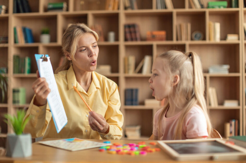 A speech-language pathologist is examining whether a child's speech errors are caused by a tongue-tie.