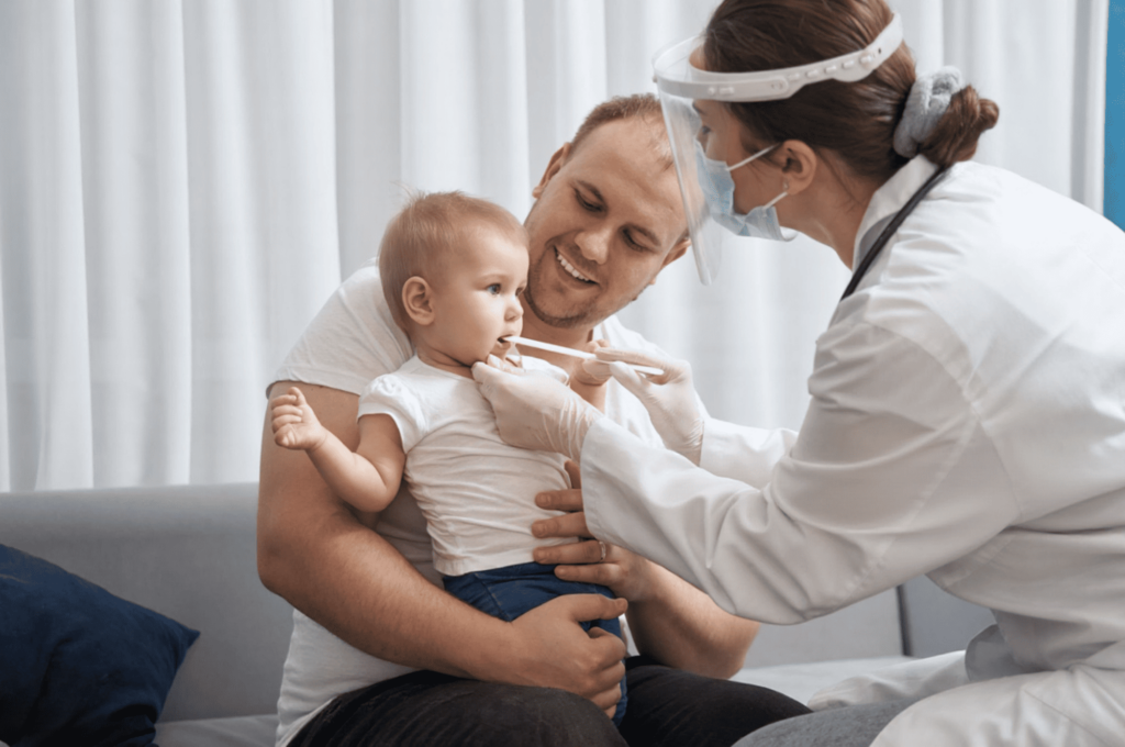 A dentist is checking an infant for tooth decay.