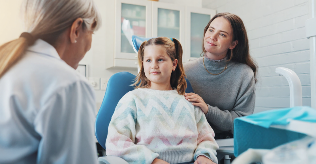 A parent is discussing sedation levels with the dentist for her daughter's dental treatment.